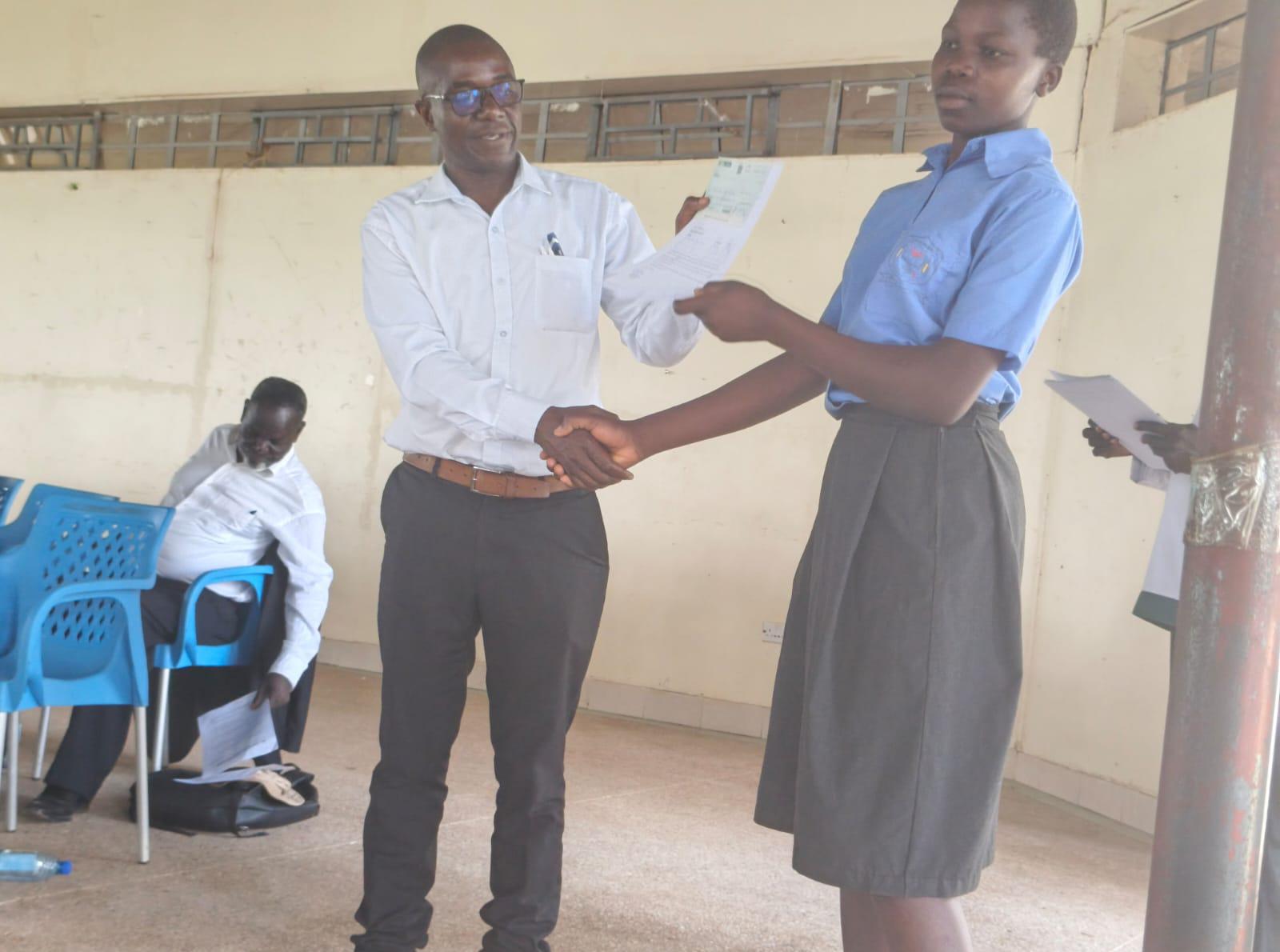 KCB Bank Official from Mumias Branch issuing a Cheque to the beneficiary